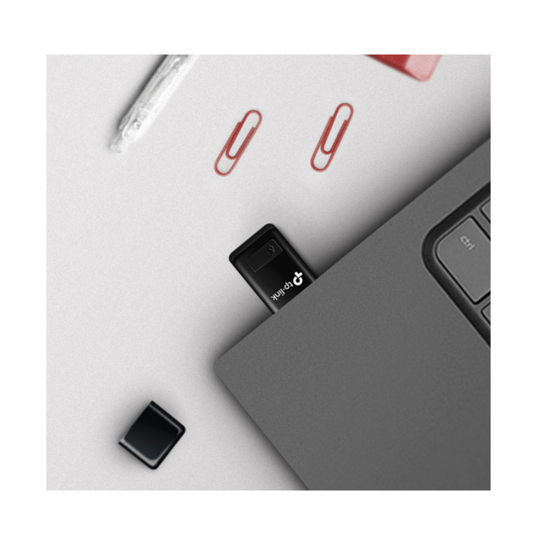 Close-up of a USB drive on a desk with office supplies