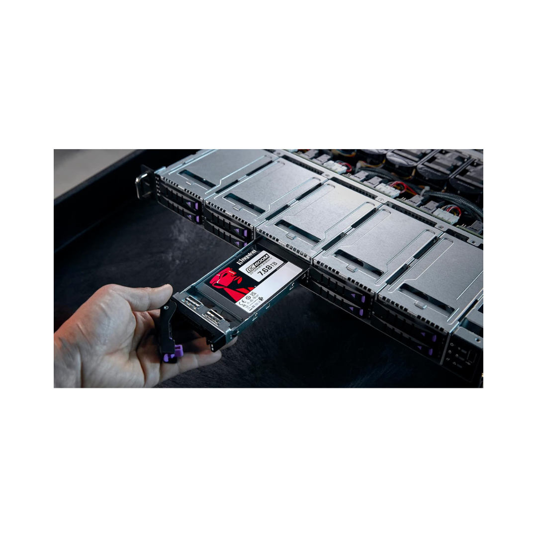 Hand holding a hard drive with a server rack in the background