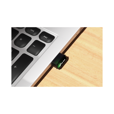 USB drive attached to a laptop on a wooden surface