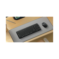 Keyboard and mouse on a desk with a large mouse pad