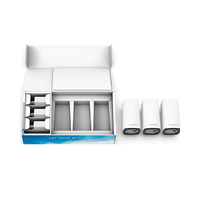 Three Linksys Wi-Fi routers next to their packaging on a white background