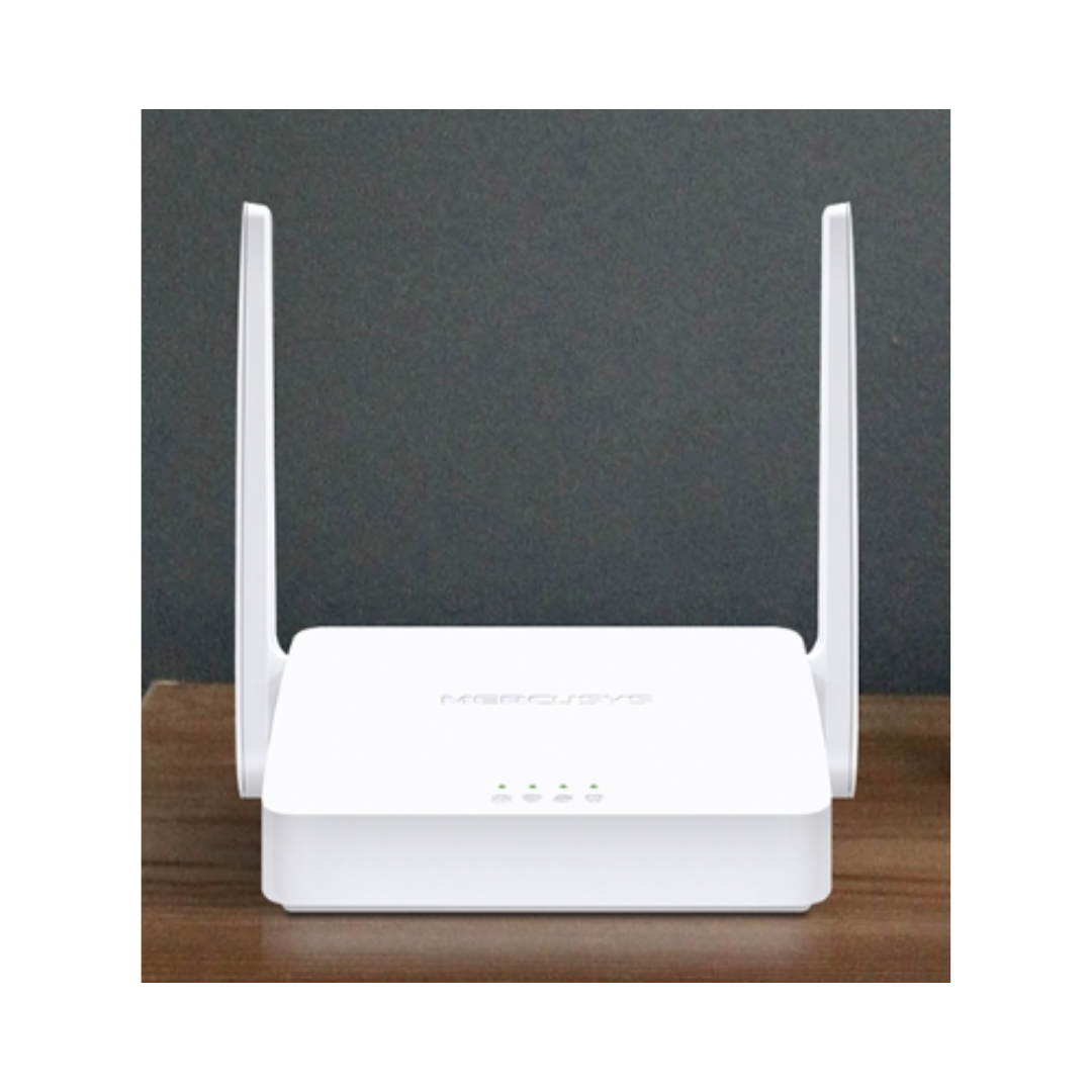 White wireless router with antennas on a wooden surface and dark background