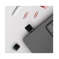 Close-up of a USB drive on a desk with office supplies