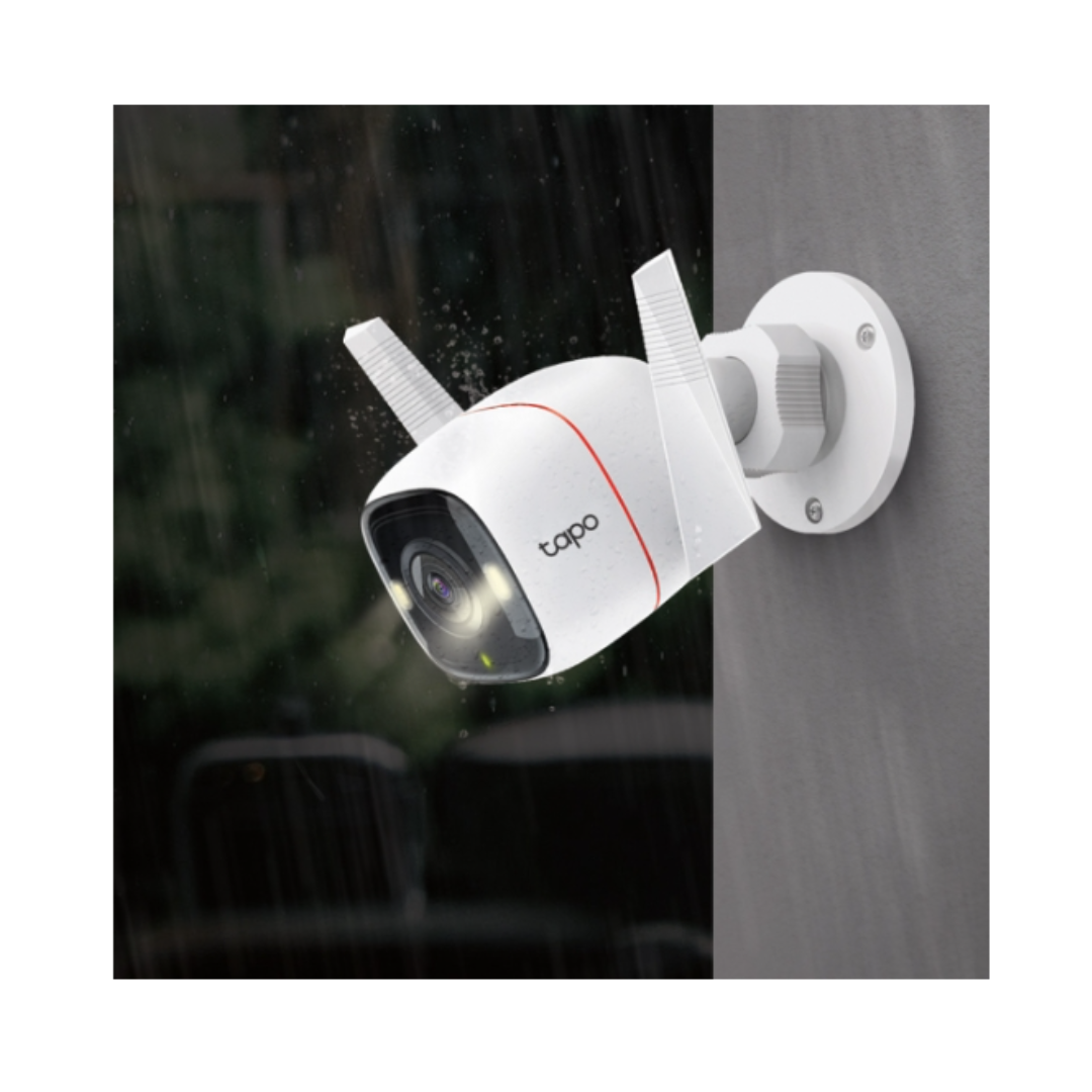 White TP-Link security camera with antennas attached to a wall.