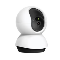 White security camera with black lens on a white background