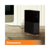 Black external hard drive with dimensions displayed on a wooden surface