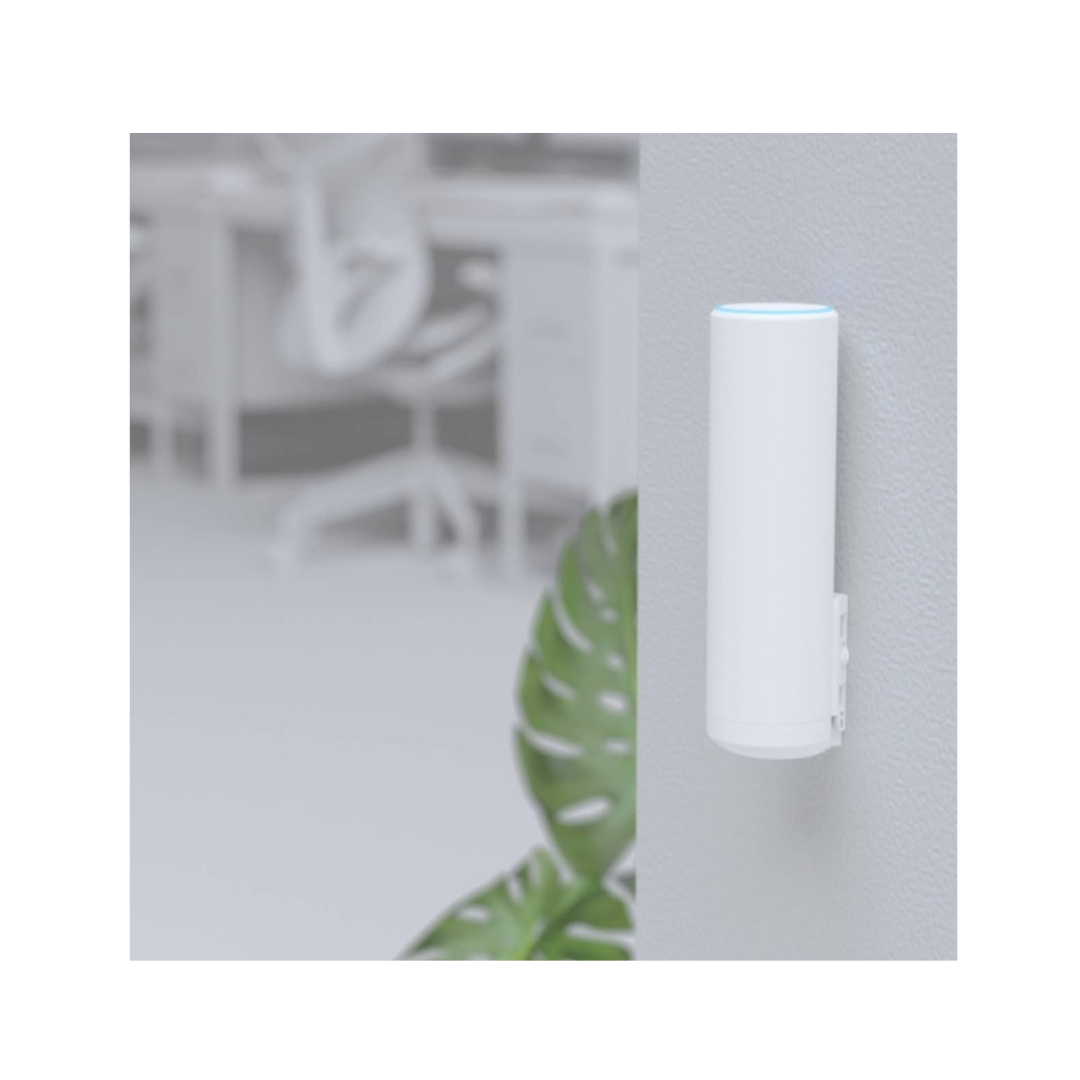White cylindrical device with blue light on a blurred background