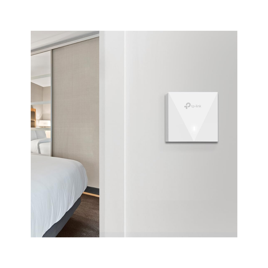 White wall-mounted device with a brand logo in a bedroom setting