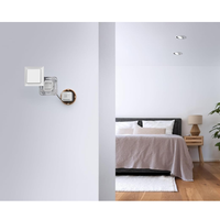 Modern bedroom with bed, nightstands, and wall sconces.