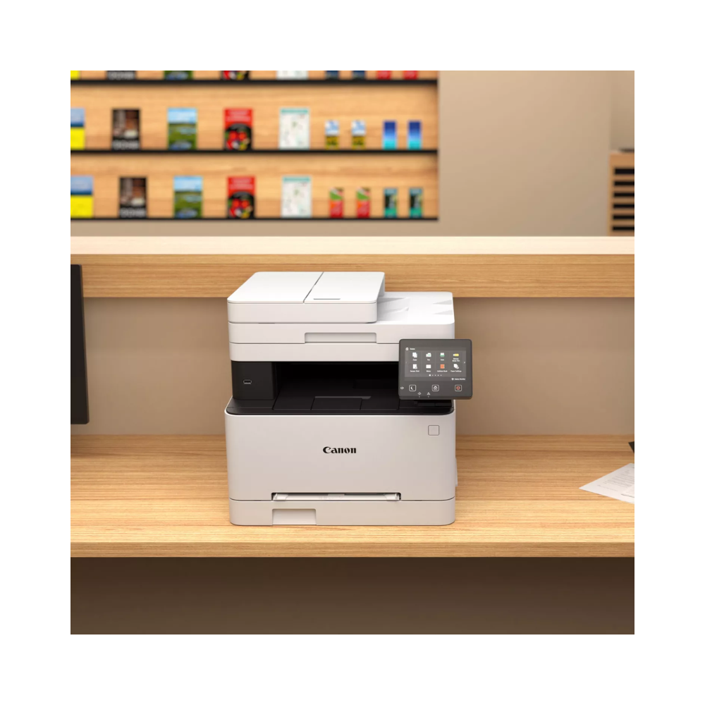 Canon printer on a wooden desk with a store shelf in the background