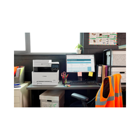 Office desk with computer, printer, and safety vest