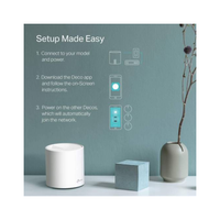 Smart home device setup guide with a white cylindrical device, blue cube, and vase on a light surface.
